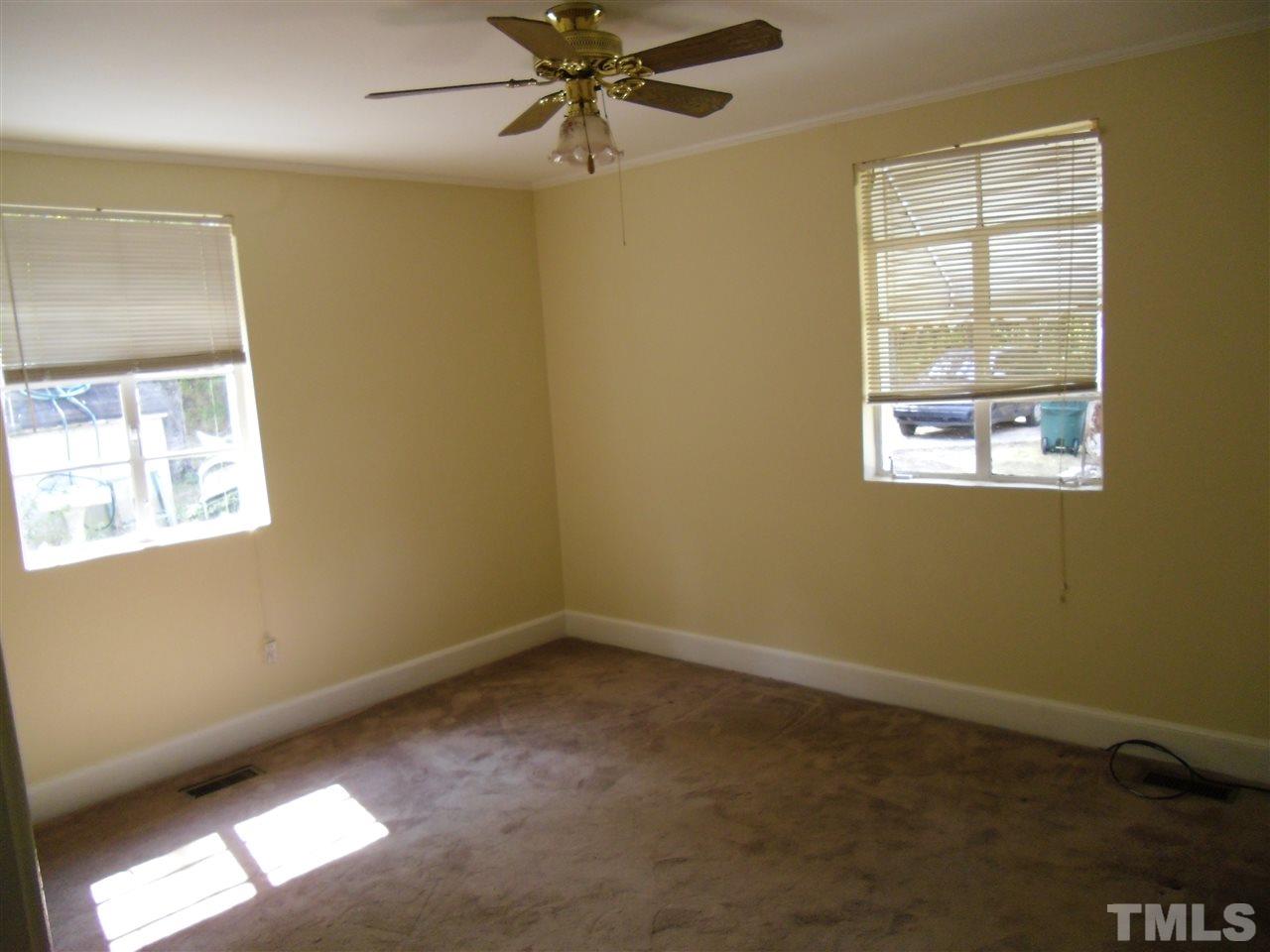 2304 Cheek Road Durham, NC 27704 - Photo 5 of 8 an empty room with a window