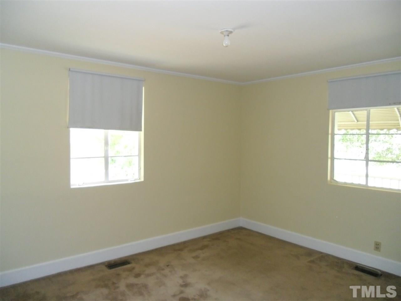 2304 Cheek Road Durham, NC 27704 - Photo 6 of 8 an empty room with a window