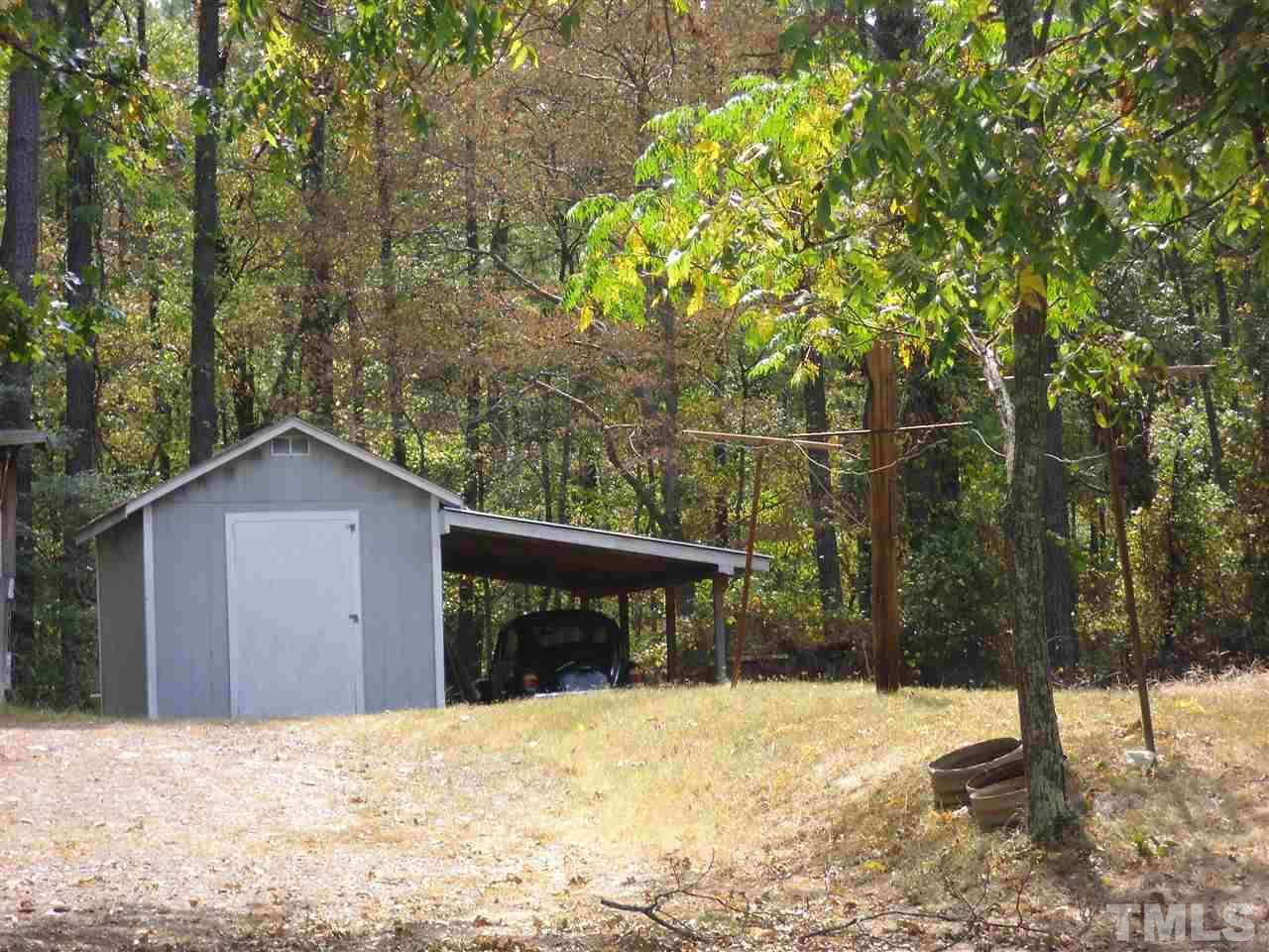 2304 Cheek Road Durham, NC 27704 - Photo 7 of 8 a view of a wooden house with a yard