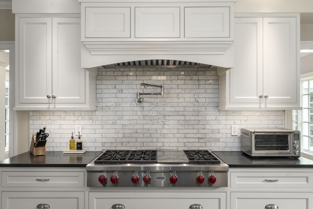 12 Pheasant Landing Road Needham, MA 02492 - Photo 13 of 42 a kitchen with granite countertop cabinets and stove