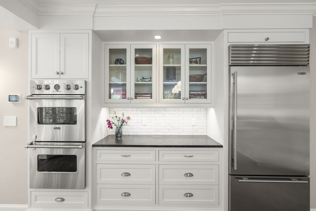 12 Pheasant Landing Road Needham, MA 02492 - Photo 14 of 42 a kitchen with granite countertop white cabinets and refrigerator