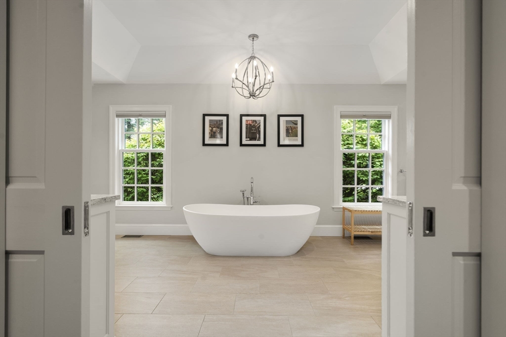 12 Pheasant Landing Road Needham, MA 02492 - Photo 22 of 42 a bathroom with a bathtub and a window