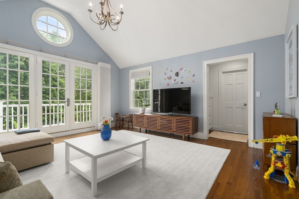 12 Pheasant Landing Road Needham, MA 02492 - Photo 30 of 42 a living room with furniture a flat screen tv and a large window