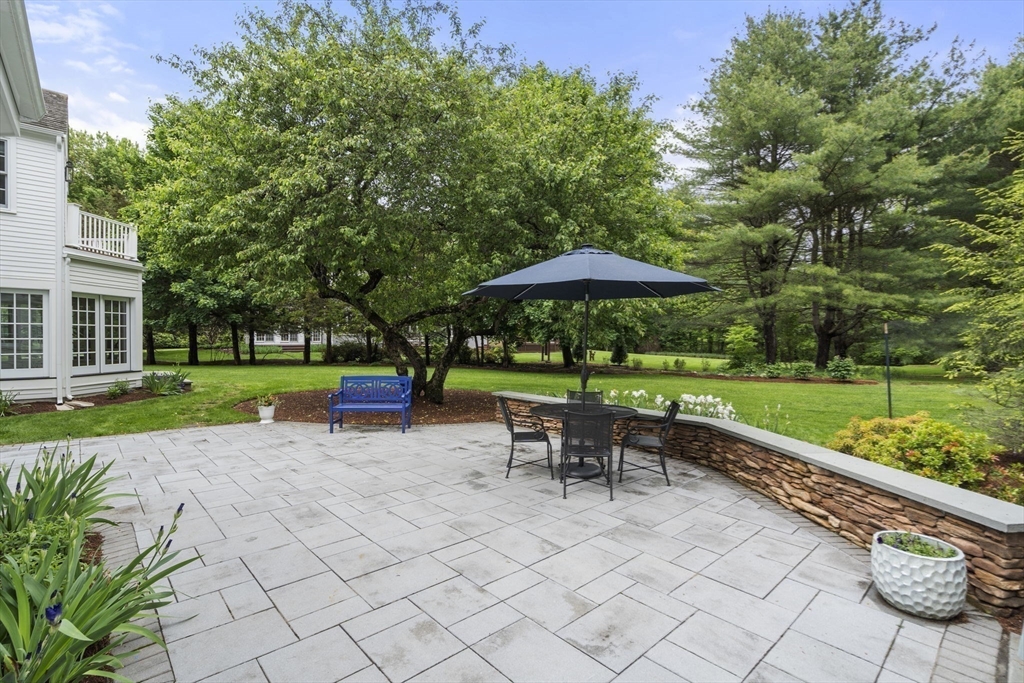 12 Pheasant Landing Road Needham, MA 02492 - Photo 39 of 42 a view of a chair and table with umbrella in the garden