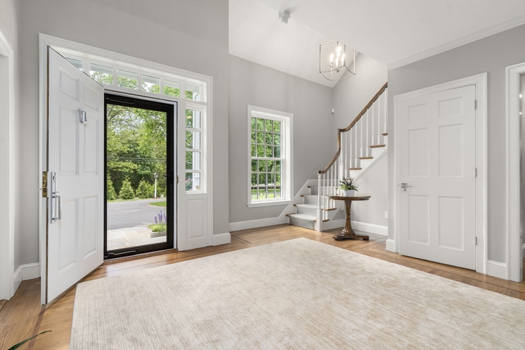 12 Pheasant Landing Road Needham, MA 02492 - Photo 5 of 42 a view of an empty room with a fireplace and a window