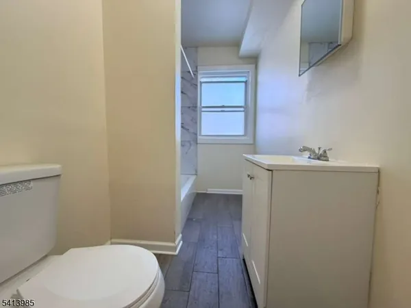 a bathroom with a sink a toilet and vanity