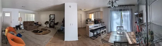 a view of a livingroom with wooden floor and a fireplace