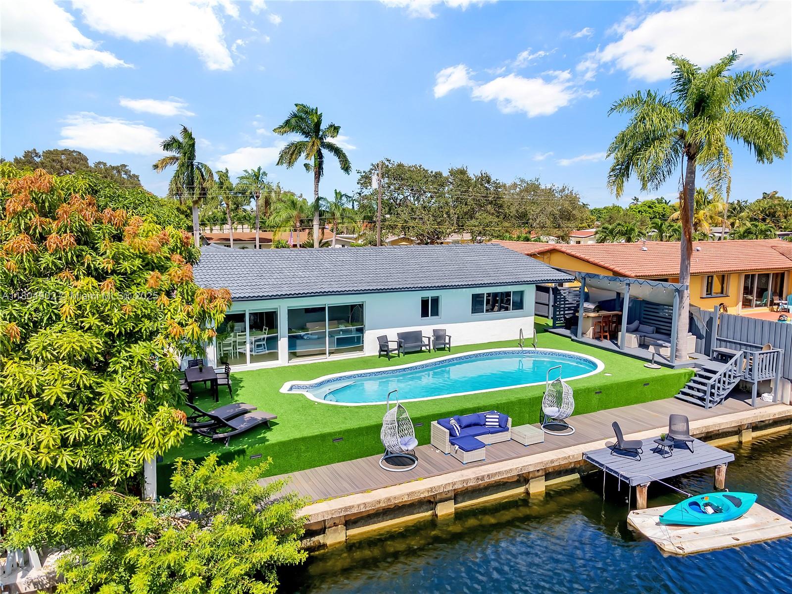 a front view of a house with swimming pool having outdoor seating