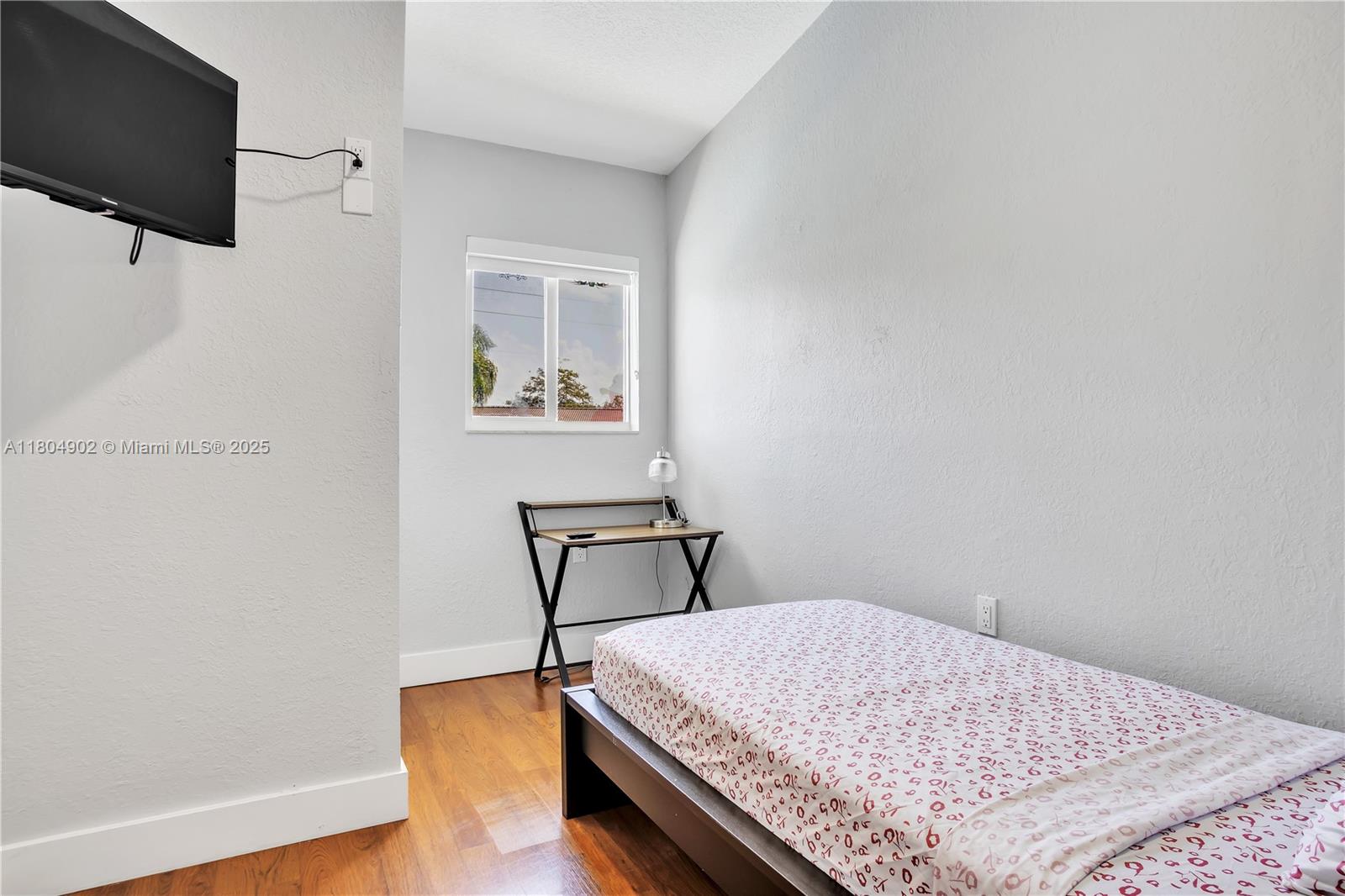 2828 Cleveland Street Hollywood, FL 33020 - Photo 15 of 23 a bedroom with a bed and a flat screen tv