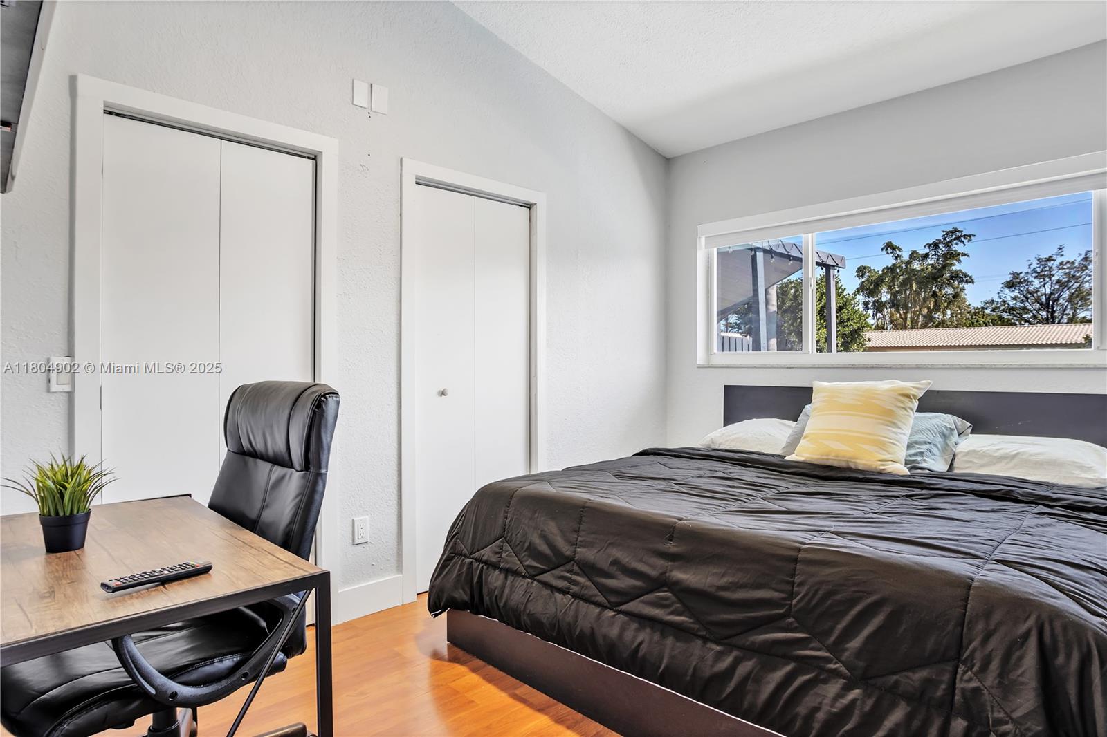 2828 Cleveland Street Hollywood, FL 33020 - Photo 19 of 23 a bedroom with a large bed and a chair