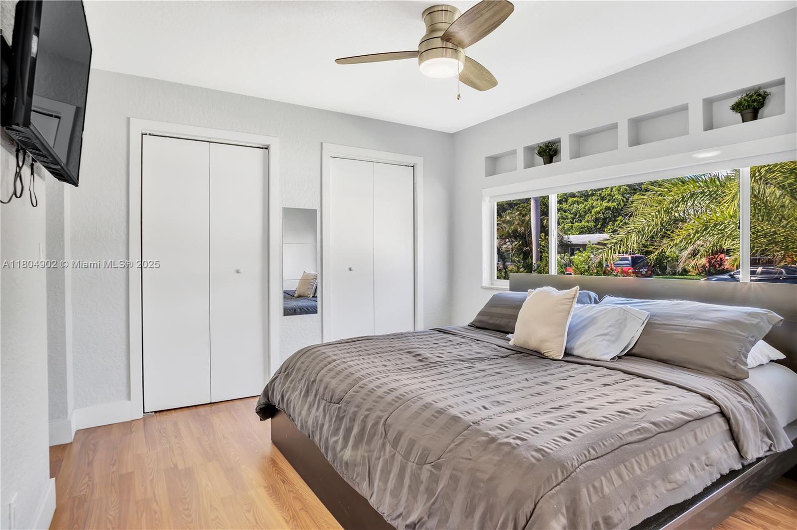 2828 Cleveland Street Hollywood, FL 33020 - Photo 22 of 23 a bedroom with a large bed and a flat tv screen on dresser
