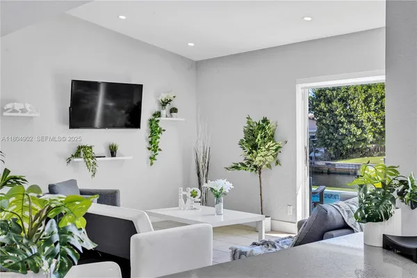 a view of a kitchen with furniture and large windows