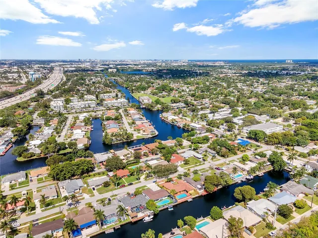 a view of house with swimming pool outdoor seating