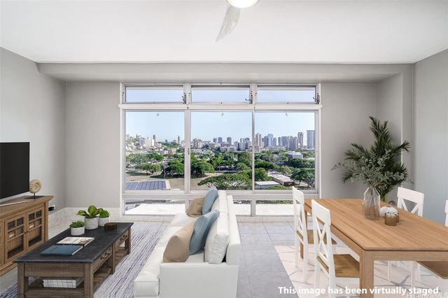 a living room with furniture a large window and a flat screen tv