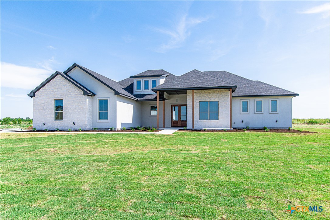 a front view of a house with a garden