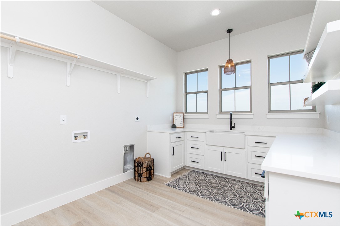 8152 Evenfall Lane Temple, TX 76501 - Photo 14 of 33 a kitchen with granite countertop white cabinets and white appliances