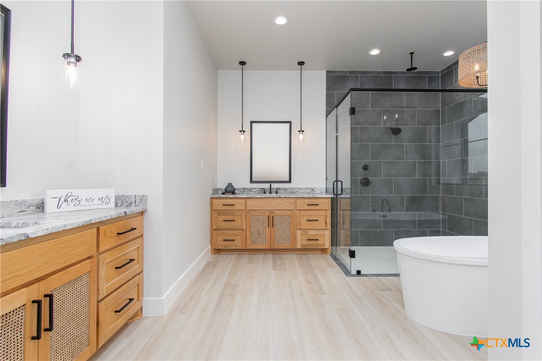 8152 Evenfall Lane Temple, TX 76501 - Photo 19 of 33 a bathroom with a double vanity sink a toilet a mirror and shower