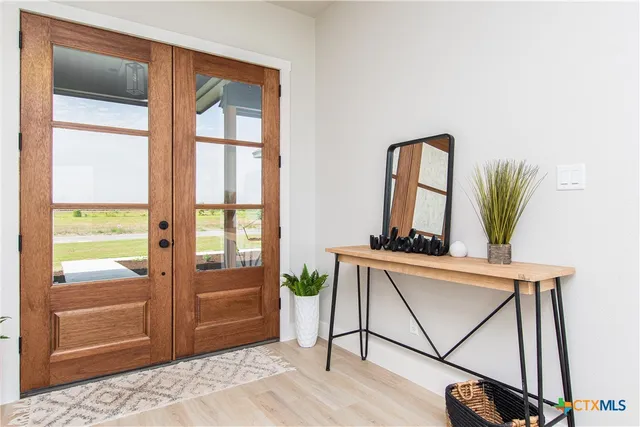 a living room with a bed furniture and a window