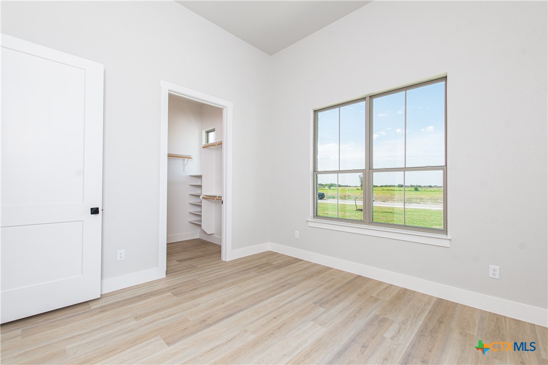 8152 Evenfall Lane Temple, TX 76501 - Photo 23 of 33 an empty room with wooden floor and windows