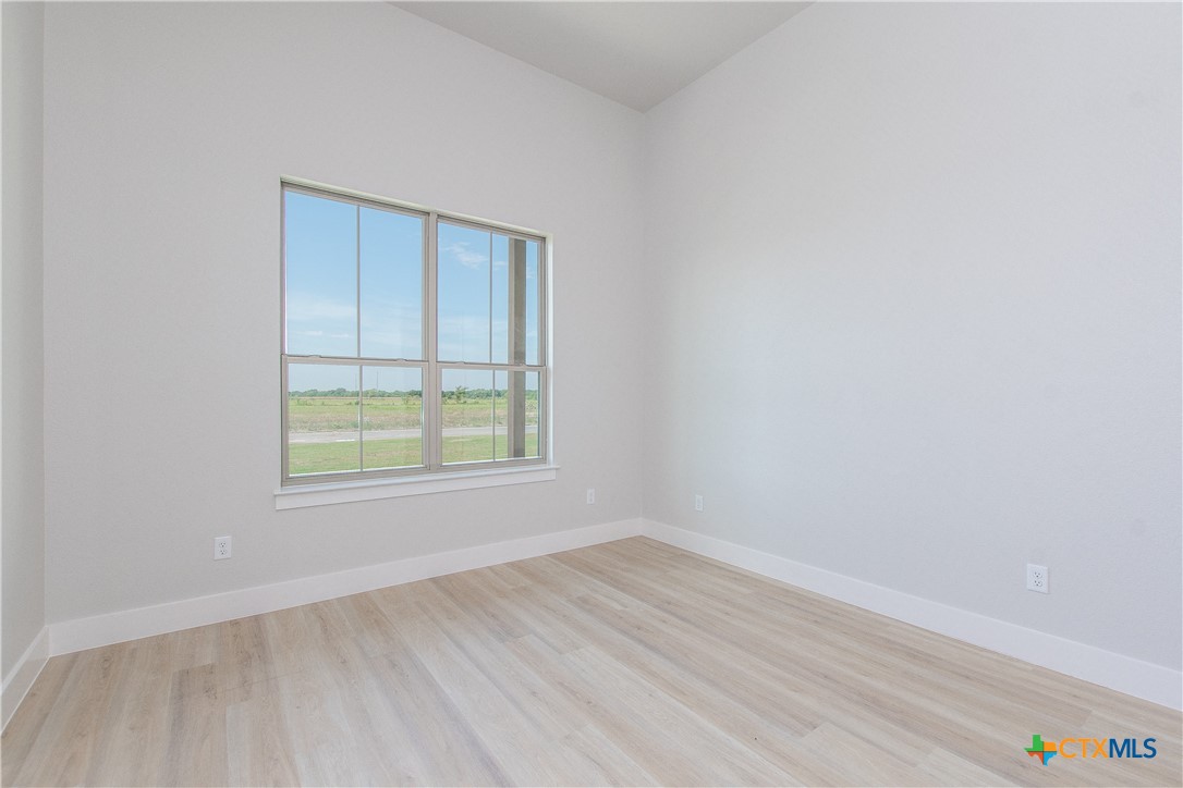 8152 Evenfall Lane Temple, TX 76501 - Photo 27 of 33 an empty room with wooden floor and windows