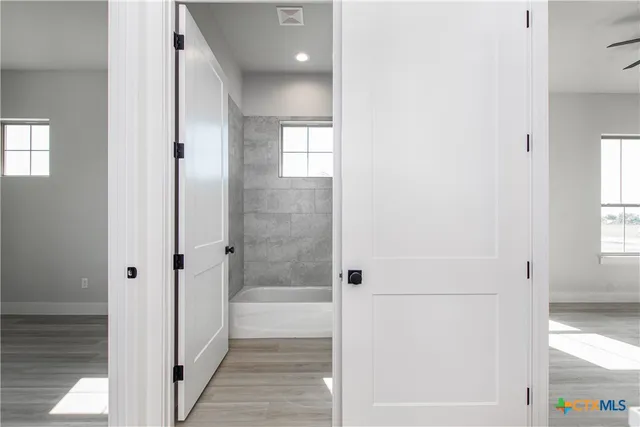 a bathroom with a bathtub and shower