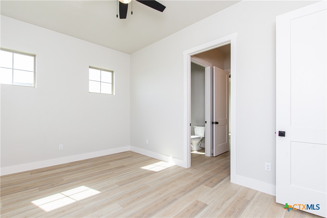 8152 Evenfall Lane Temple, TX 76501 - Photo 30 of 33 an empty room with wooden floor and windows