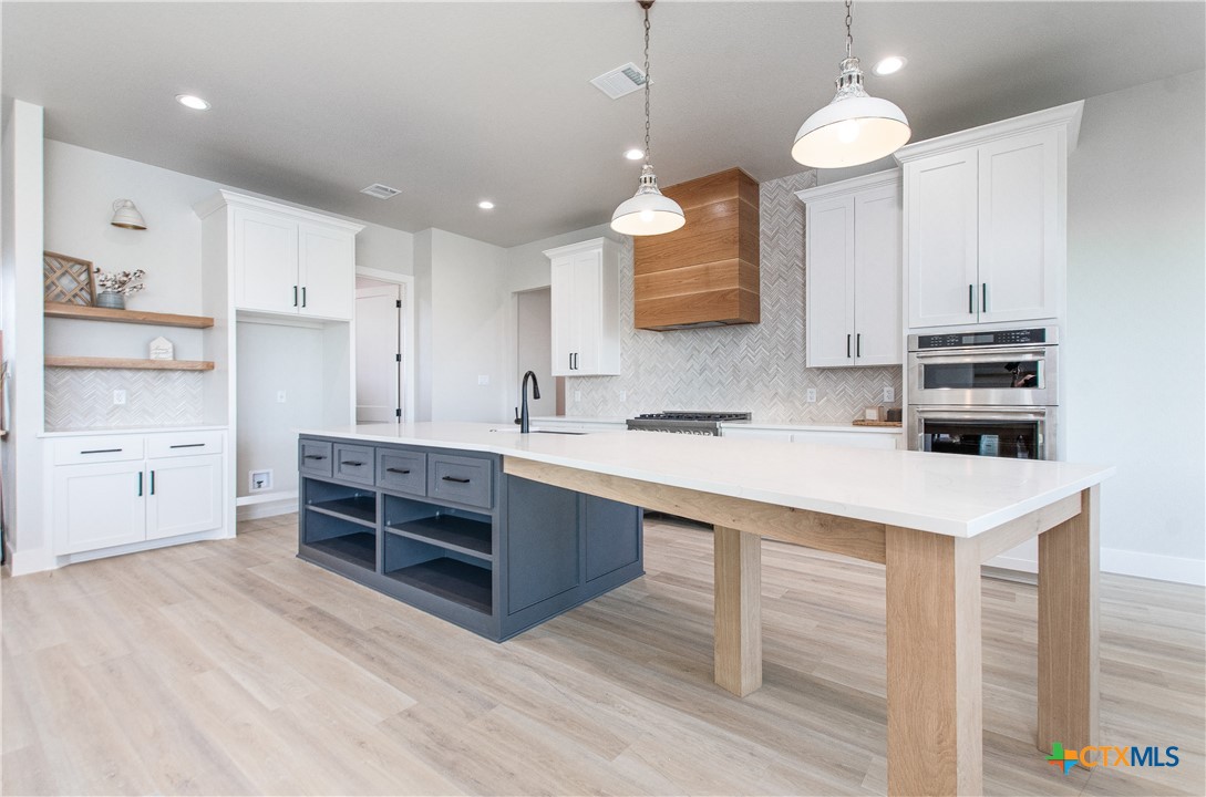 8152 Evenfall Lane Temple, TX 76501 - Photo 9 of 33 a kitchen with kitchen island a sink stainless steel appliances and cabinets