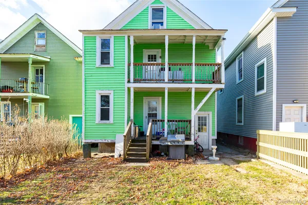 a view of a house with a patio and a yard