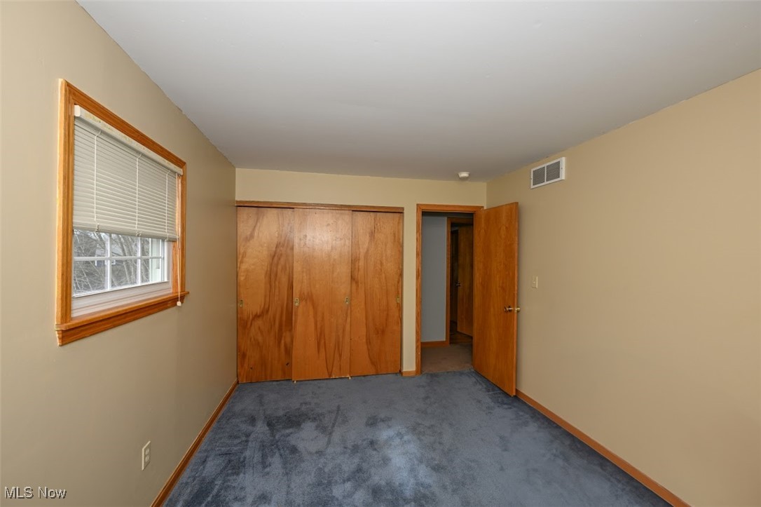 3305 Edington Road Akron, OH 44333 - Photo 28 of 46 Unfurnished bedroom featuring carpet flooring, baseboards, visible vents, and a closet