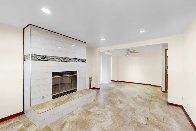 a view of a livingroom with a fireplace cabinet and window