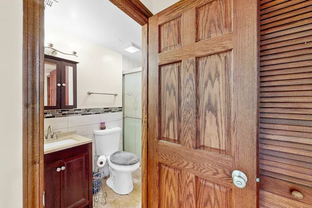 a bathroom with a toilet a sink and a mirror