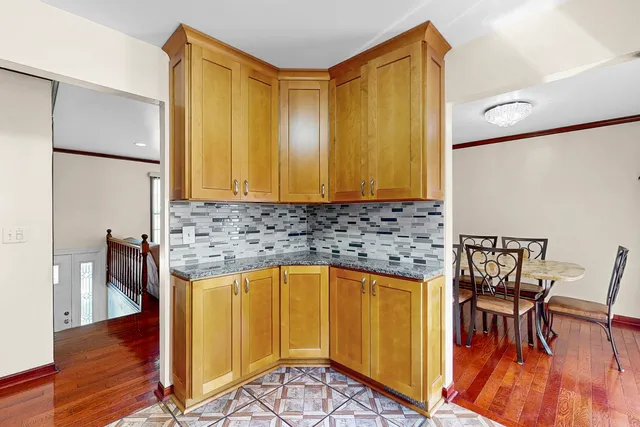 a kitchen with a sink a table and chairs in it