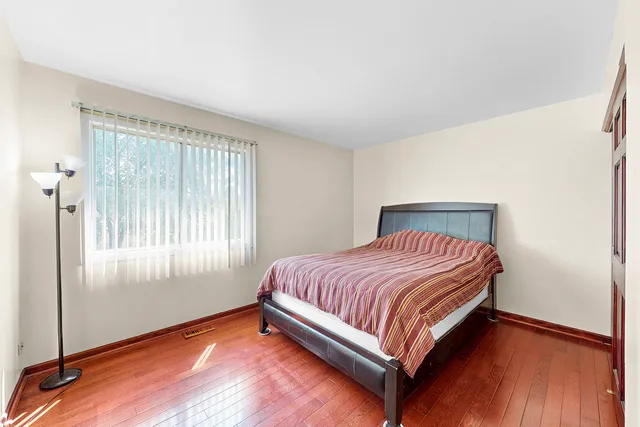 a bed sitting in a room next to a window