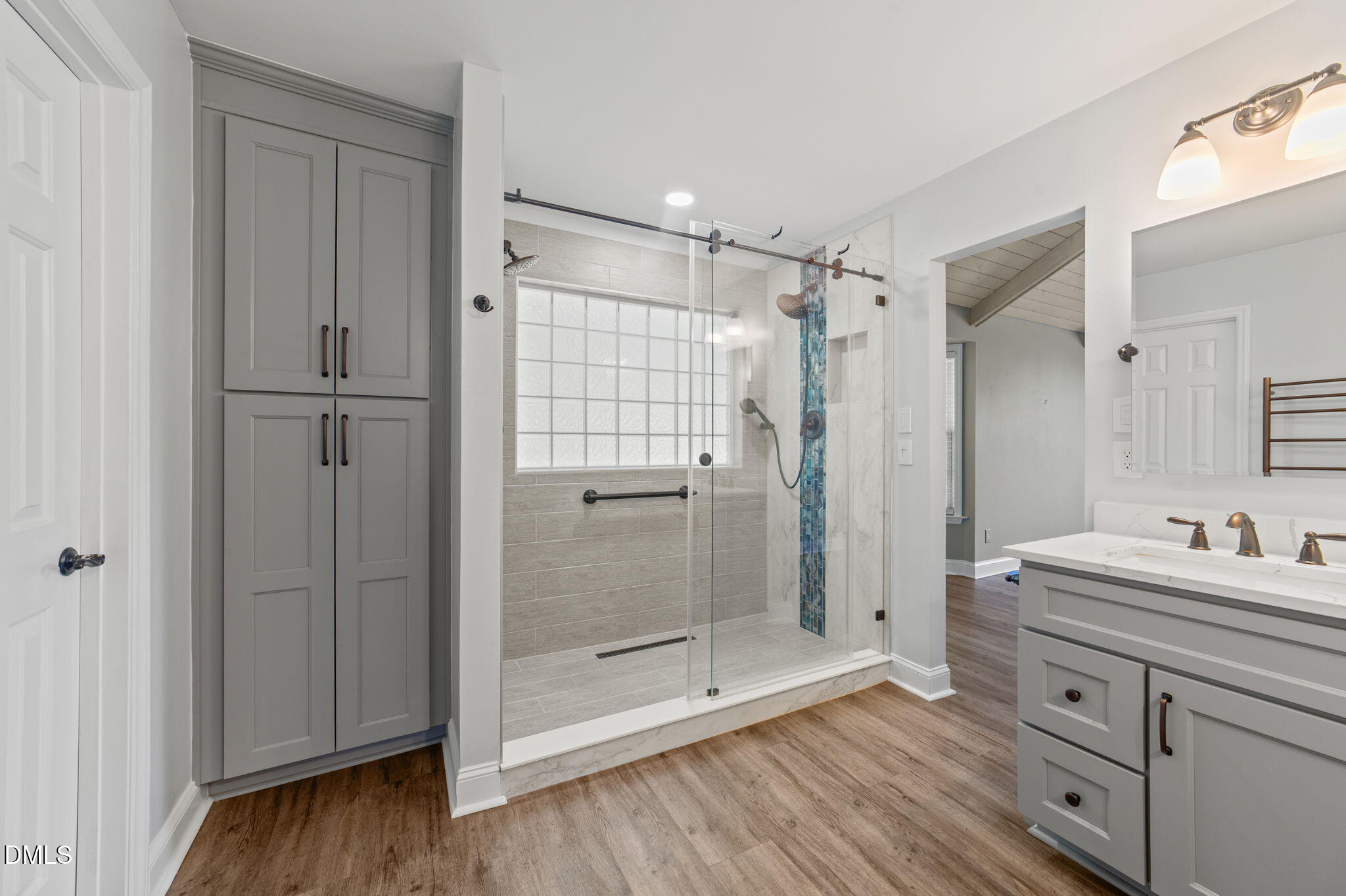 6820 Oviedo Drive Raleigh, NC 27603 - Photo 25 of 50 a bathroom with a shower sink and mirror