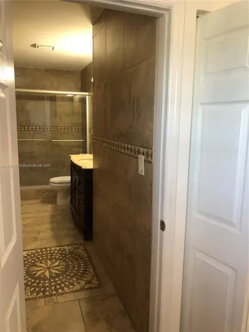 a bathroom with a glass shower door