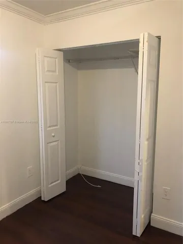 an empty room with wooden floor