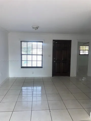 an empty room with windows and entrance