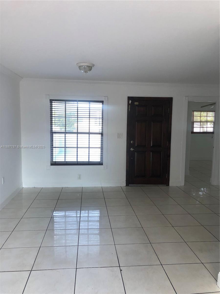 19319 Northwest 54th Court Miami Gardens, FL 33055 - Photo 3 of 20 an empty room with windows and entrance