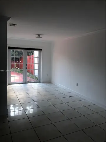 a view of an empty room with chandelier
