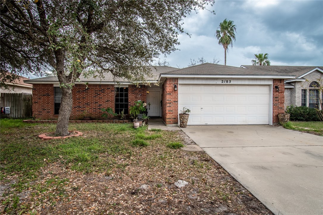 a front view of house with a garden