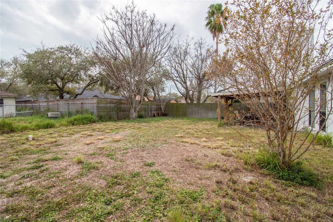 2185 Spring Park Drive Ingleside, TX 78362 - Photo 30 of 32 a view of a yard with a house and a large tree