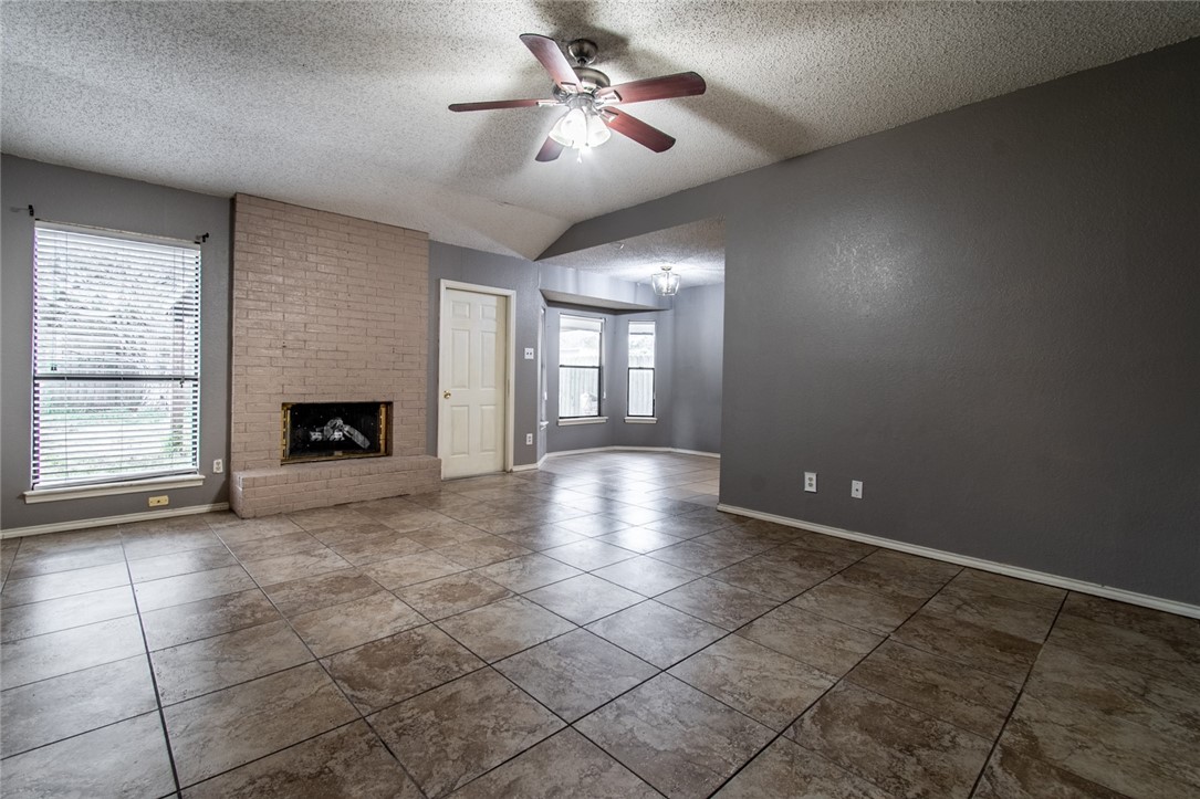 2185 Spring Park Drive Ingleside, TX 78362 - Photo 4 of 32 a view of an empty room with a fireplace and a window