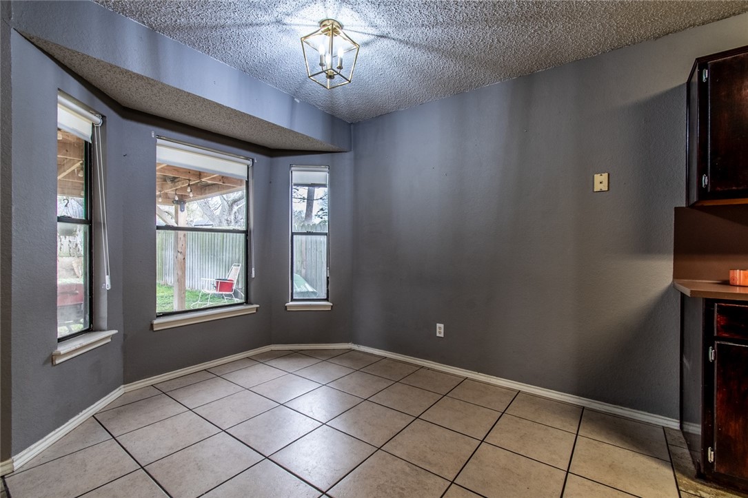 2185 Spring Park Drive Ingleside, TX 78362 - Photo 8 of 32 a view of an empty room with window and chandelier