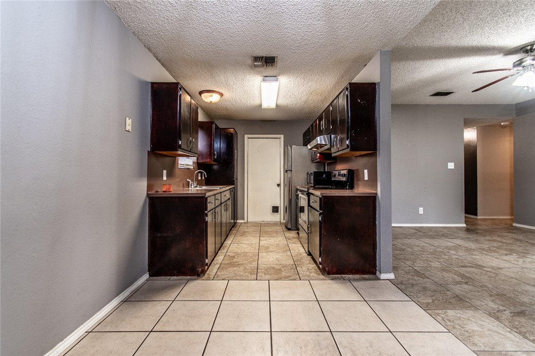 2185 Spring Park Drive Ingleside, TX 78362 - Photo 9 of 32 a kitchen with a cabinets and steel stainless steel appliances