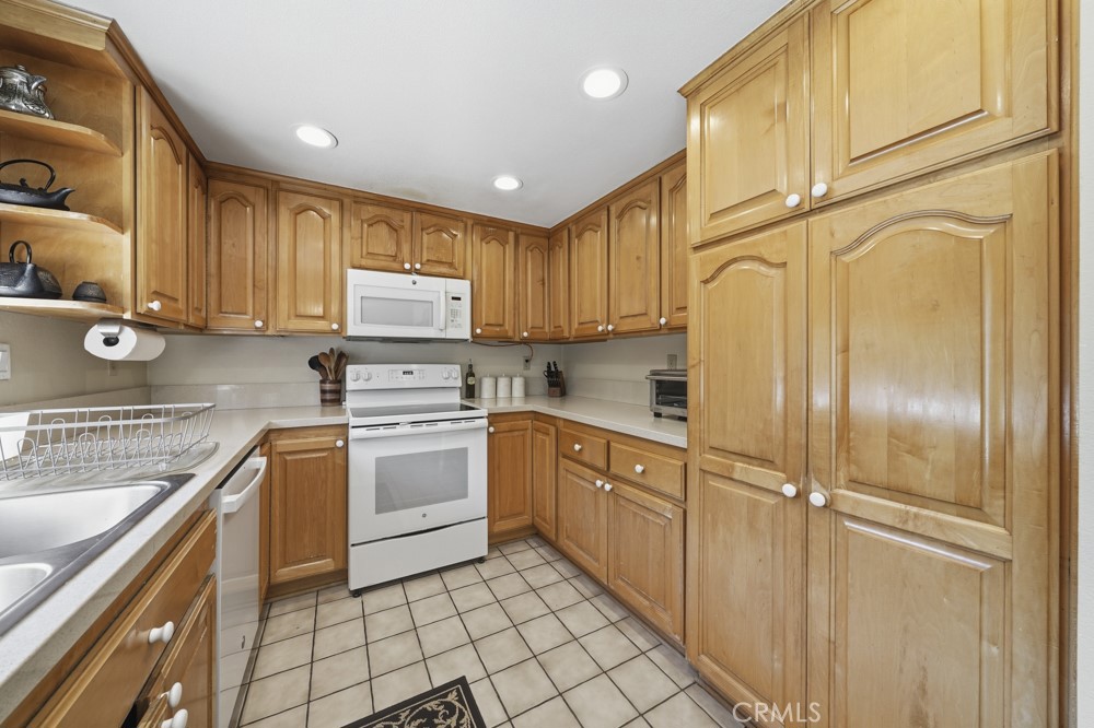 5 Eden Irvine, CA 92620 - Photo 16 of 42 a kitchen with cabinets stainless steel appliances and a counter space