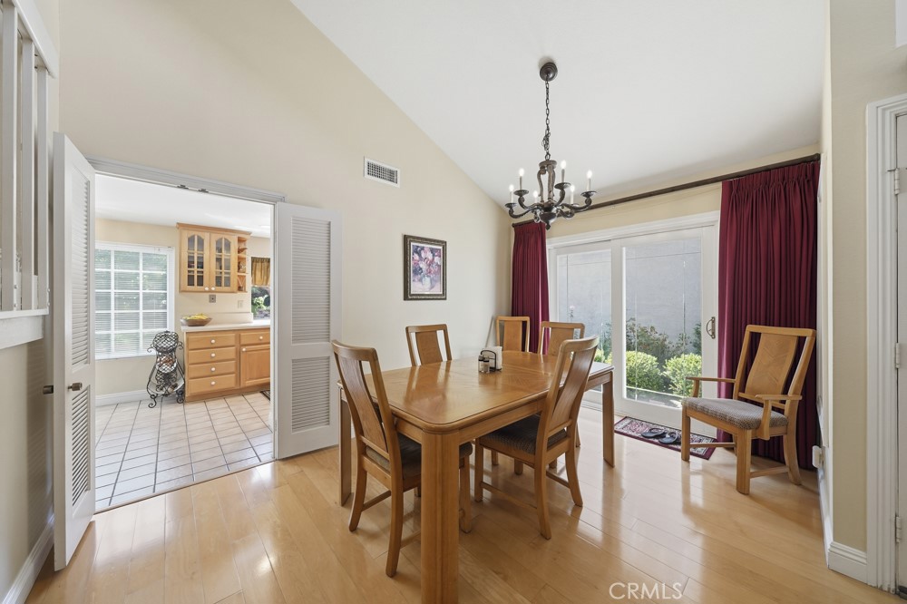 5 Eden Irvine, CA 92620 - Photo 18 of 42 a dining room with furniture a chandelier and wooden floor