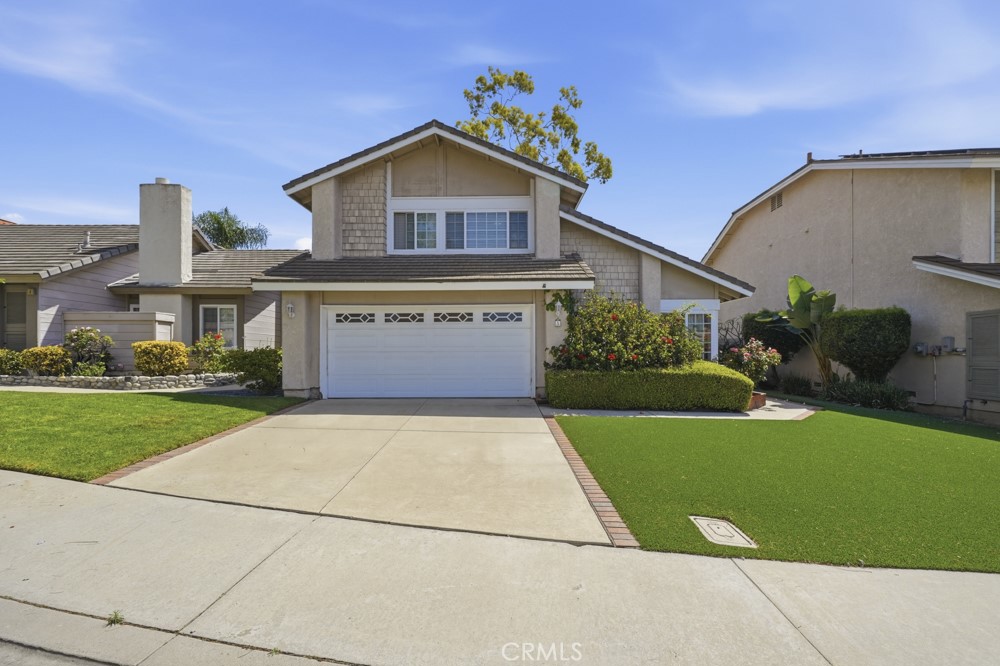 5 Eden Irvine, CA 92620 - Photo 2 of 42 a front view of a house with a yard and garage