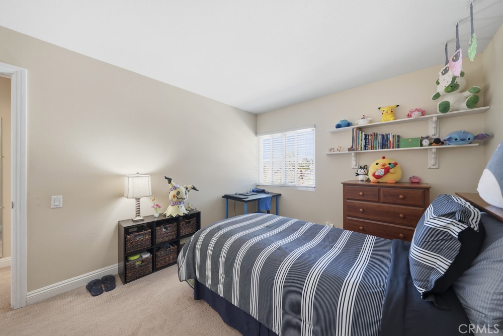 5 Eden Irvine, CA 92620 - Photo 30 of 42 a bedroom with a bed and a dresser in it