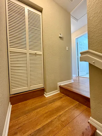 a view of a room with wooden floor