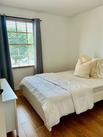 a bathroom with a granite countertop sink a toilet and a mirror